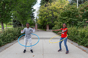 Photo of two kids playing with hula hoops at Mission Park