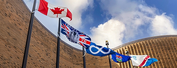 Flags (Canadian, Treaty 6, Metis, Provincial and Municipal) waving out front of St. Albert Place