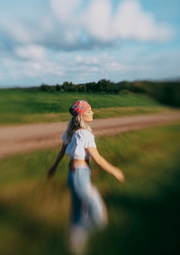 Jimi spinning in a field by an old dirt road.