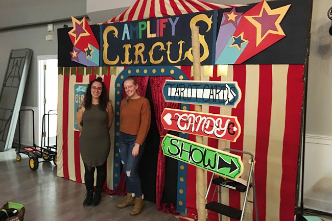 Artist and Mentor Artist standing in front of a completed Photo Booth Project, which looks like a circus tent.
