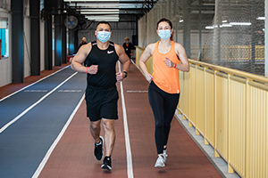 Photo of Gregory and Joanna running on the track.