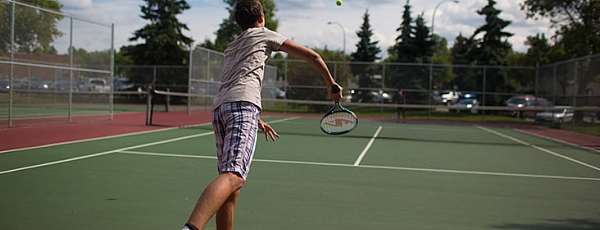 Tennis player serving on the court
