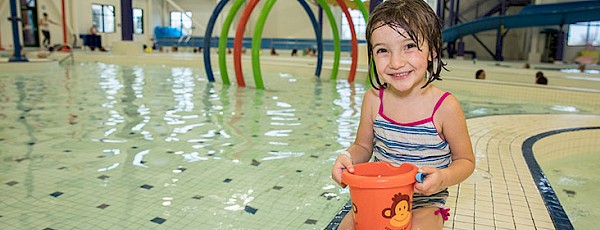 Photo of young swimmer at the Water Play Centre; holding a water toy
