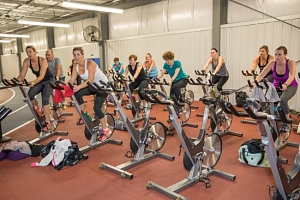 adults taking part in group spin class