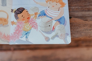 Illustration from "Kindness is a Golden Heart." Illustration by Charlene Chua. One child is singer into a spoon, while another child drums on pots and pans.