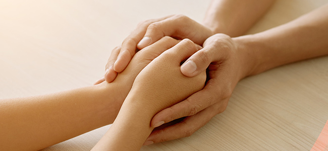 Two people holding hands