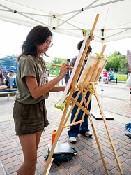 Artist painting at easel