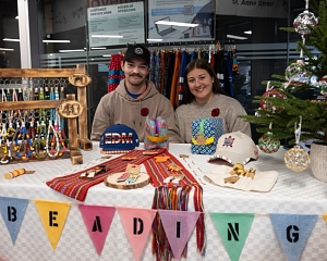 Vendors smiling at their market table