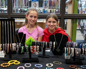 Vendors smiling at their market table