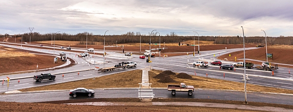 Construction workers complete the finishing touches on a new intersection at Ray Gibbon Drive and LeClair Way