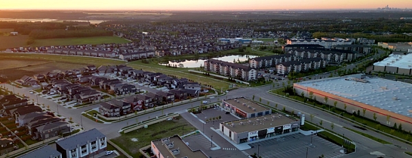 An aerial view of Erin Ridge North at sunset showing a mix of housing and commerical development