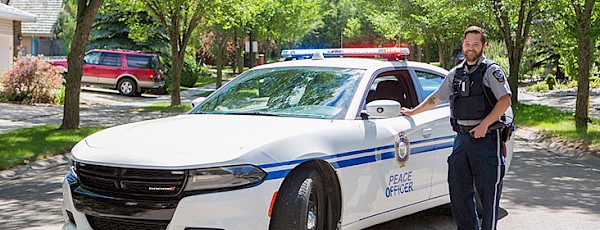 Peace Officer standing in front of his vehicle