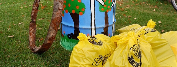 Painted trash can and garbage bags