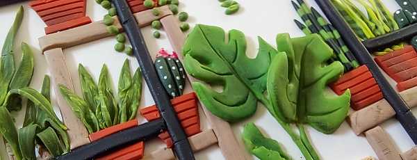 Detail of an artwork of a greenhouse made from polymer clay.