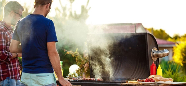 Person standing in front of a BBQ