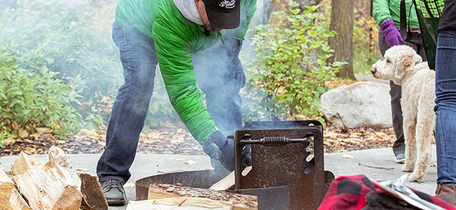 Person tending to a fire pit