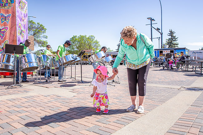 Grandparent walking with toddler