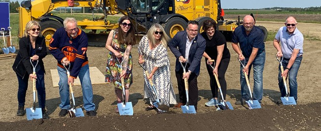 Government dignitaries standing with silver plated shovels line up to officially break ground on Lakeview Business District, one of Alberta's newest and largest business districts