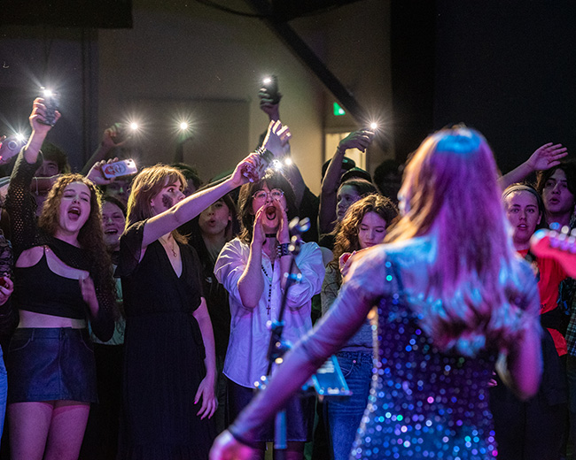 Performer singing to a crowd