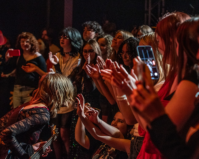 Performer singing to a crowd