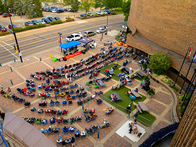 Aerial view of a Plaza Series performance in front of St. Albert Place