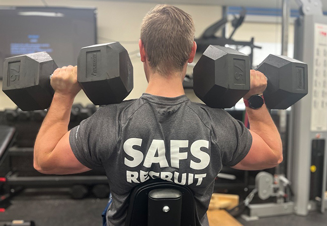 A firefighter lighting weights in a gym