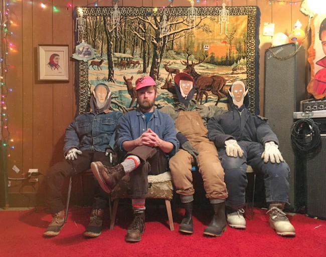 Artist, Nikelas "Smokey" Johnson sits with his artwork.