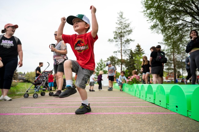 a child dances on a musical art installation