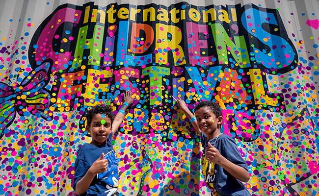 Kids infront of Children's Festival Sign