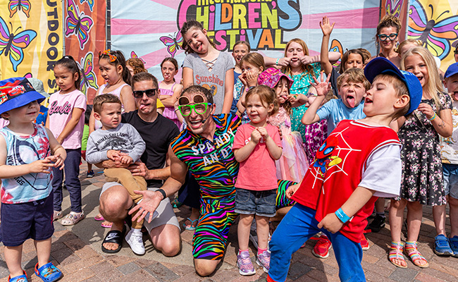 Spandy Andy surrounded by smiling children