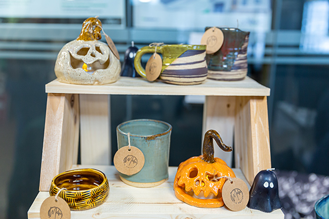 Pottery sitting on a wood stand
