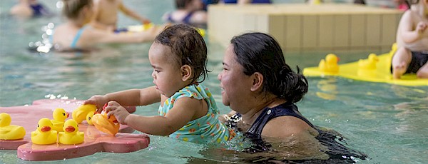 Mom swimming with baby.