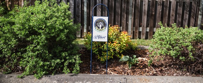 A garden with a Spruce Up St. Albert sign