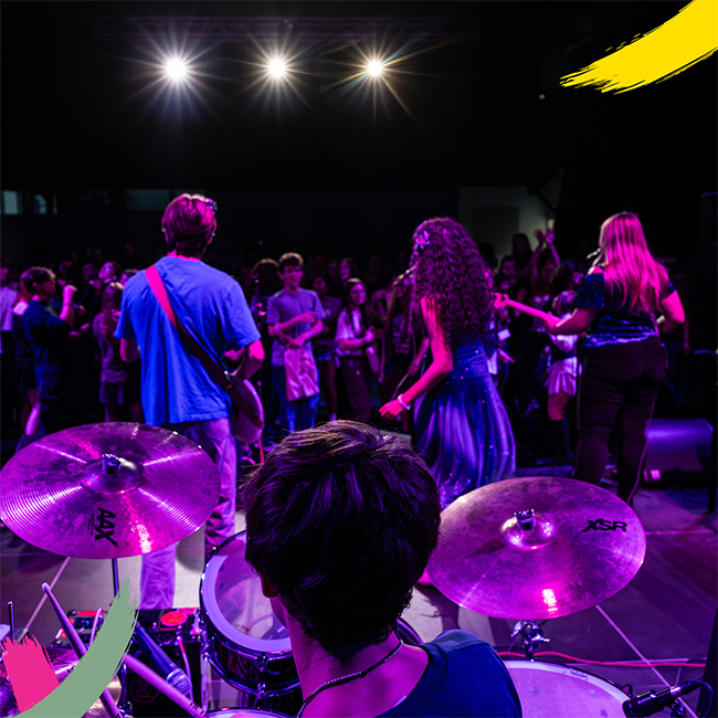Musicians on stage singing in front of a crowd