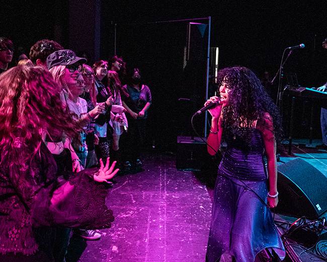 Musician singing in front of a crowd