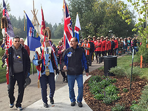 Leaders, Elders, RCMP and Public walking to Healing Garden