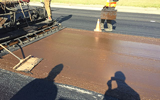 Another layer of asphalt being applied