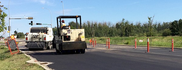 A City crew paves an arterial road